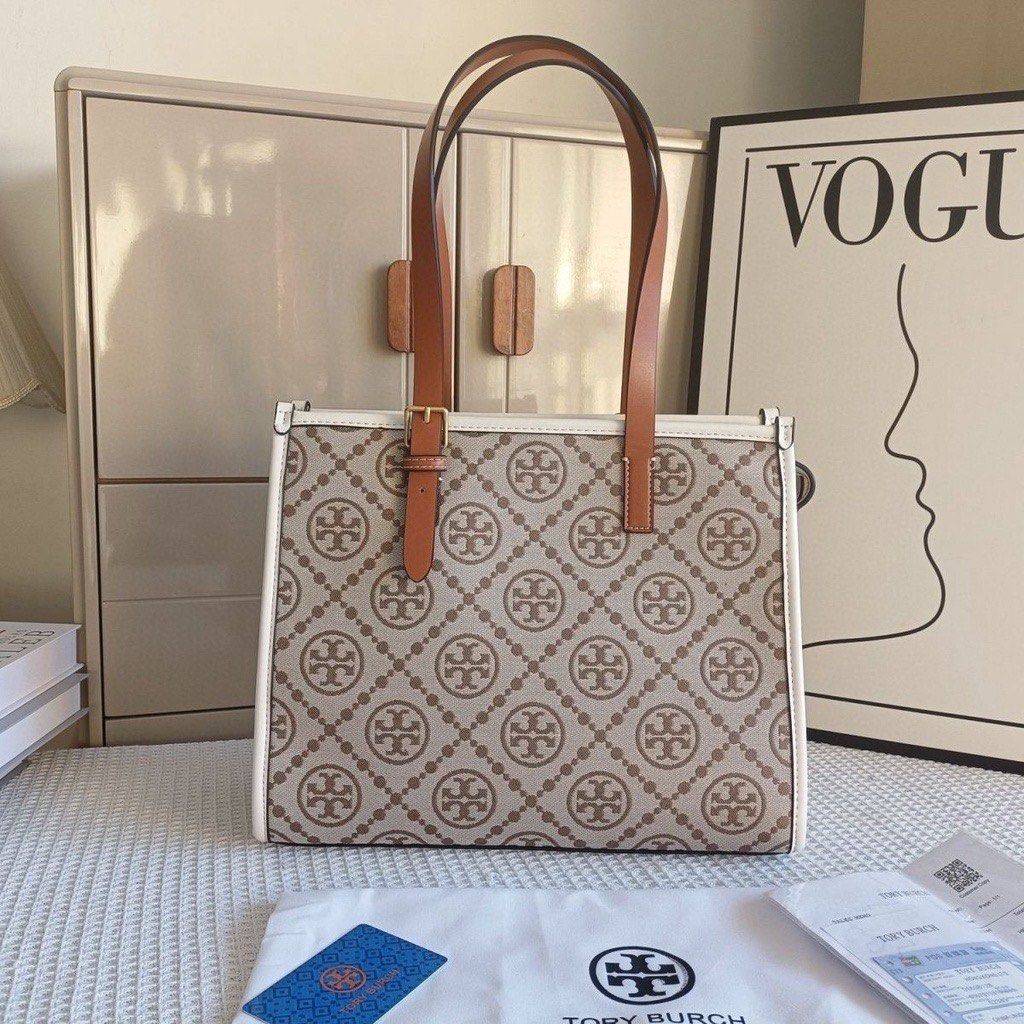 Tory Burch Tote Bag - Monogram Print (Category: Luxury Bags & Wallets) located in Manila. Submitted by ann_05_755 (Listing ID 1450948122, Image 1). Description: - Classic Tory Burch tote bag - Signature all-over monogram print - Tan leather straps and trim - Perfect everyday size -Bought it for 8k in USA -Pm me for more pictures, price is negotiable -RFS need funds.