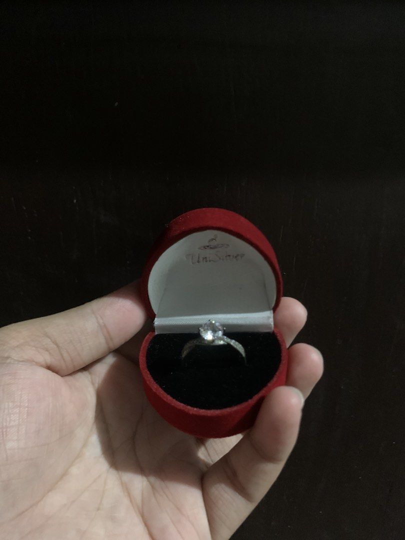 UNISILVER - 925 Sturling Silver Diamond Ring (Category: Rings) located in Manila. Submitted by djustkoni.29 (Listing ID 1450986999, Image 2). Description: Selling a beautiful UniSilver engagement-style ring. Perfect as a promise ring, fashion accessory, or placeholder ring! Brand: UniSilver Jewelry Material: Genuine 925 Sterling Silver Stone: Brilliant Round-Cut Cubic Zirconia (CZ) Condition: Great to Good condition, very shiny and well-kept. Inc