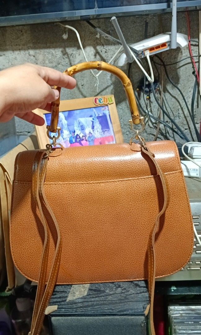 Vintage bamboo bag (Category: Luxury Bags & Wallets) located in Davao. Submitted by dgs143 (Listing ID 1450941688, Image 2). Description: StudioBell Bamboo Handle Handbag Classic bamboo handle and turn-lock closure Beautiful camel brown color Structured design Includes original care card Clean exterior and overall good condition Issue: Interior lining has peeling due to age (please see photos). Does not affect the bag's overall appearance when ca