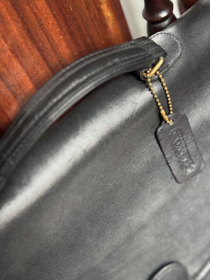 Rare Vintage Coach Leather briefcase (Category: Luxury Bags & Wallets) located in Paranaque City. Submitted by mykindofclothing (Listing ID 1450964058, Image 2). Description: Authentic Vintage Coach briefcase. produced in the early to mid-1990s. Black leather, Made in USA. Secure clasp, adjustable strap. Spacious interior. Shows nice patina. Classic professional style. Well maintained with Bickmore 4 leather conditioner. Leather feels buttery and