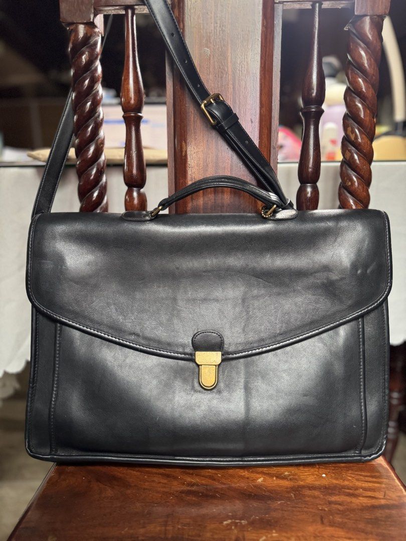 Rare Vintage Coach Leather briefcase (Category: Luxury Bags & Wallets) located in Paranaque City. Submitted by mykindofclothing (Listing ID 1450964058, Image 1). Description: Authentic Vintage Coach briefcase. produced in the early to mid-1990s. Black leather, Made in USA. Secure clasp, adjustable strap. Spacious interior. Shows nice patina. Classic professional style. Well maintained with Bickmore 4 leather conditioner. Leather feels buttery and