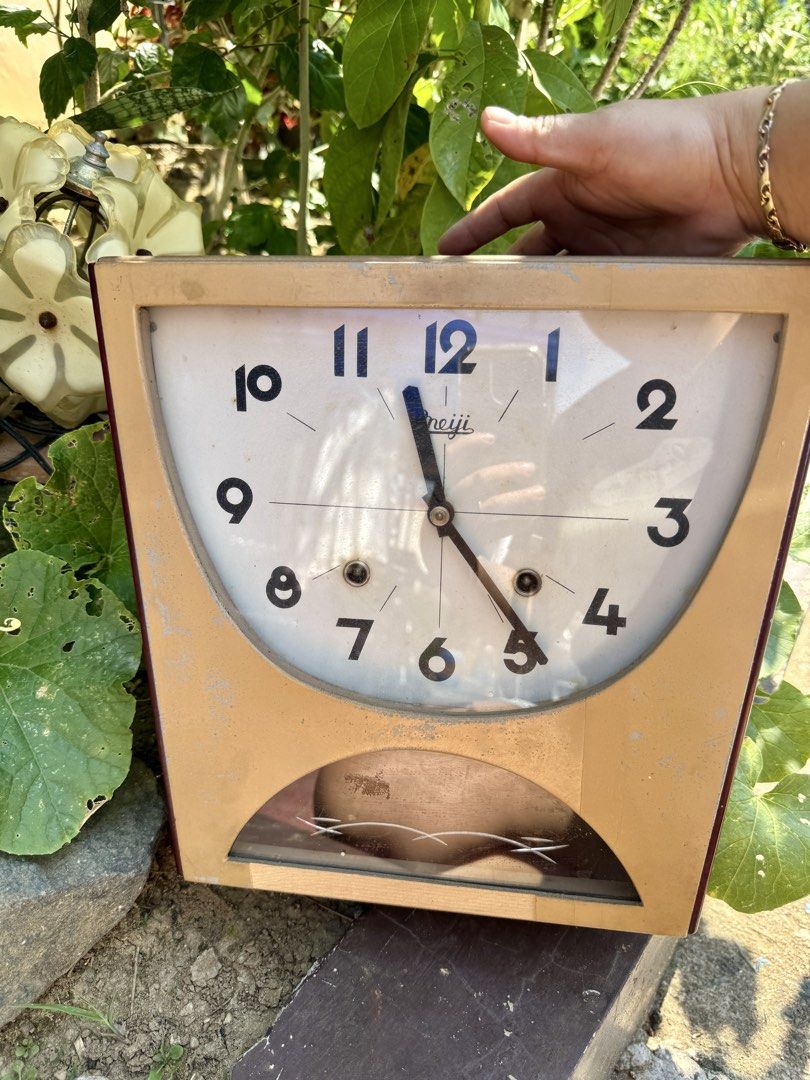 Vintage Meiji pendulum wall clock (Category: Clocks) located in Cainta. Submitted by danica010314 (Listing ID 1451066944, Image 1). Description: - Unique curved design - Arabic numerals on the face - Pendulum at the bottom - Wooden casing with signs of age - Mechanical clock, likely requires winding - Ideal for collectors or retro home decor.