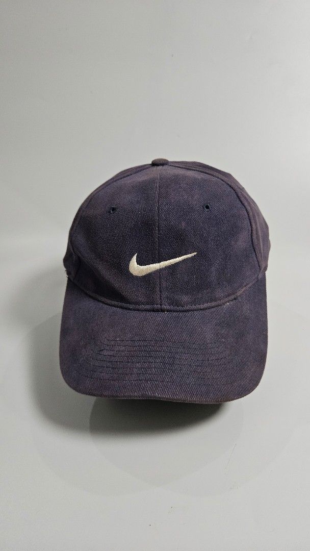 Vintage mid swoosh Nike Baseball Cap (Category: Caps & Hats) located in Alfonso. Submitted by jbcamet (Listing ID 1451034297, Image 1). Description: - Classic Nike baseball cap - Dark navy blue color - Adjustable strap at the back - Versatile for everyday wear - Shows some signs of use, but plenty of life left - Perfect for sunny days or casual outfits.