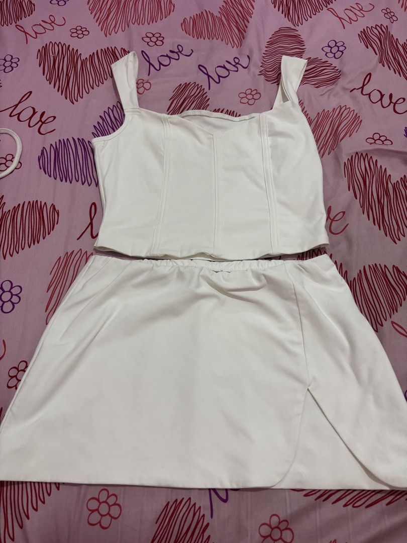 White Corset Top and Skirt Set (Category: Sets or Coordinates) located in Santo Tomas. Submitted by ph.trendythreads (Listing ID 1450949240, Image 1). Description: - White corset top and matching mini skirt set - Mini skirt with a stylish side slit - Ideal for night outs or special occasions - Simple yet chic design - Versatile for styling with accessories.