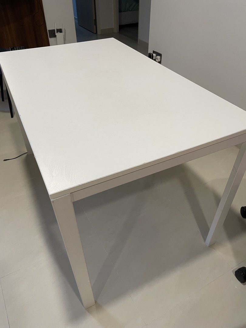 White Rectangular Dining Table (Category: Tables & Sets) located in Singapore. Submitted by moumoumoumi (Listing ID 1451079880, Image 2). Description: - Simple white rectangular table -Accessories such as screws will be provided - Versatile: Use as a work desk or dining - Sturdy legs for stability - Easy-to-clean surface - Space-saving design, great for small homes -Self collect at choa chu kang -Dismantled and Packed in bubble wrap, easy to arra
