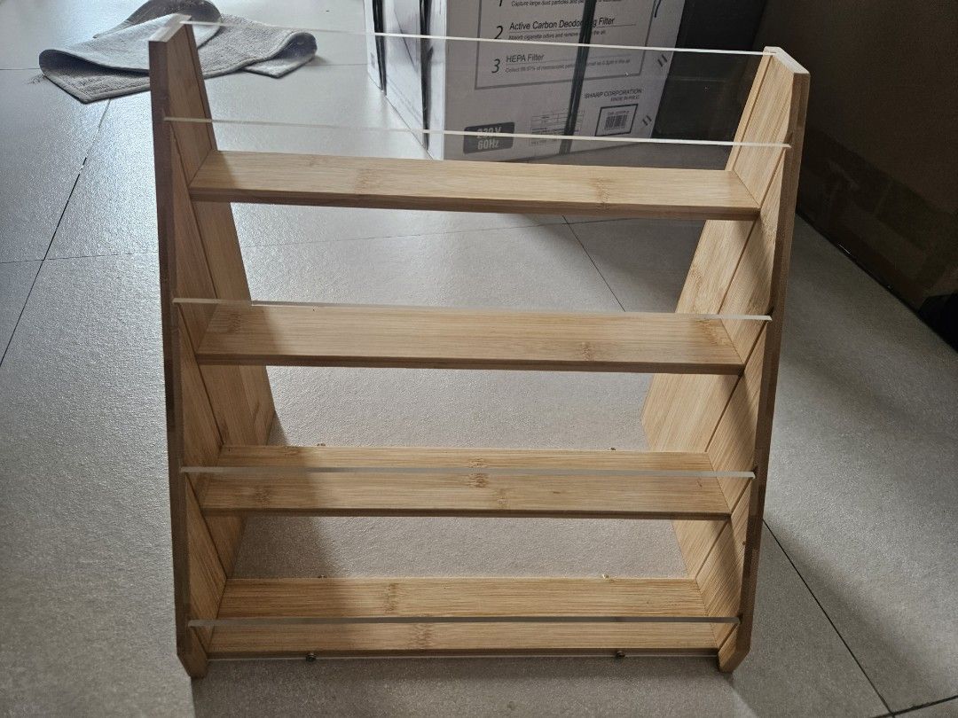 Wooden display shelf with clear acrylic front (Category: Shelves, Cabinets & Racks) located in Manila. Submitted by declutter_daruma (Listing ID 1451065806, Image 3). Description: - 4-tier display shelf - Made of durable bamboo wood - Features clear acrylic fronts on each level - Ideal for showcasing small items like collectibles or spices - Compact and space-saving design.