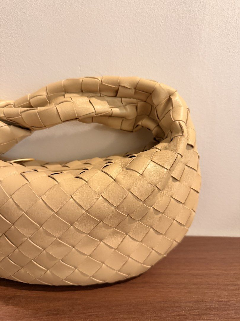 Woven Leather Knot Handle Handbag (Category: Luxury Bags & Wallets) located in Taguig. Submitted by sourcedbym (Listing ID 1451062564, Image 3). Description: - Creamy beige woven leather handbag - Unique knot handle design - Soft, rounded shape - Versatile for casual or dressed-up looks - Spacious interior for essentials - A chic and stylish accessory.