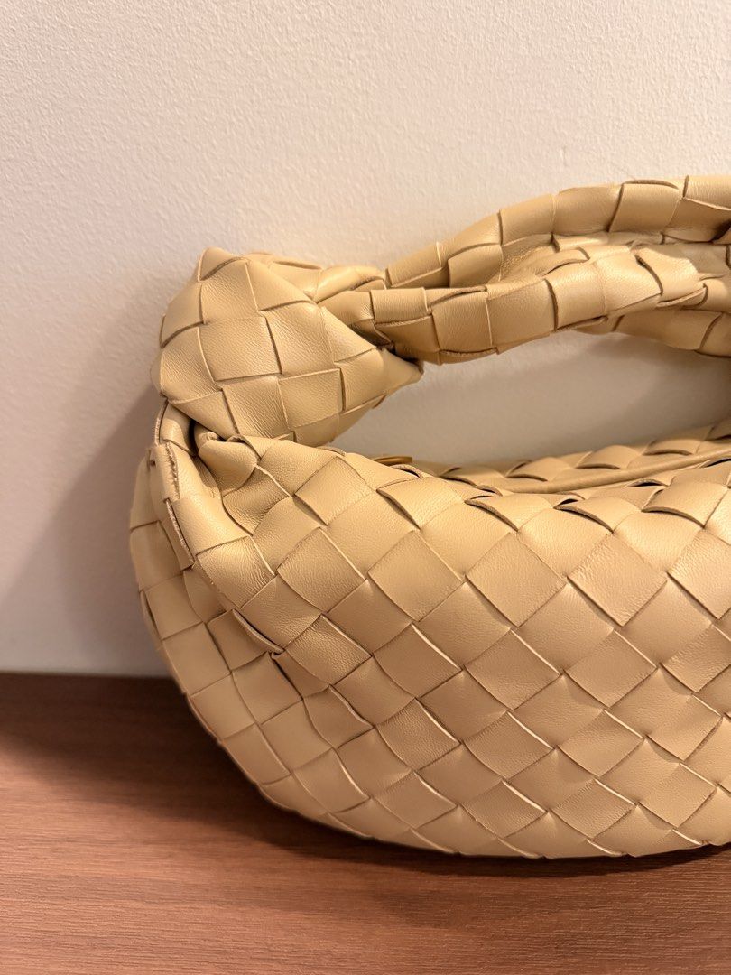Woven Leather Knot Handle Handbag (Category: Luxury Bags & Wallets) located in Taguig. Submitted by sourcedbym (Listing ID 1451062564, Image 2). Description: - Creamy beige woven leather handbag - Unique knot handle design - Soft, rounded shape - Versatile for casual or dressed-up looks - Spacious interior for essentials - A chic and stylish accessory.