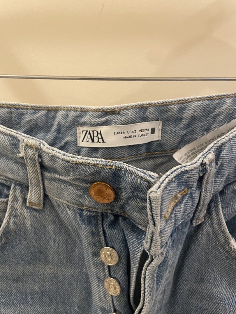 Zara High Waisted Button Fly Ripped Jeans (Category: Jeans) located in Cordon. Submitted by secondgreatt (Listing ID 1450961518, Image 2). Description: - Zara light wash denim jeans - Size EUR 34 - High waisted with button fly closure - Distressed rips on legs - Raw hem - Straight leg cut - Made in Turkey.