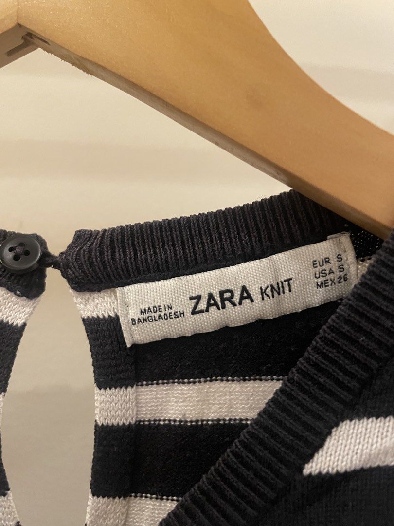 Zara Knit Striped Short Sleeve Top (Category: Blouses) located in Cordon. Submitted by secondgreatt (Listing ID 1450959522, Image 2). Description: - Zara black and white striped knit top - Features a unique yellow hem detail - Short sleeves and classic crew neck - Convenient button closure at the back of the neck - Crafted in Bangladesh.