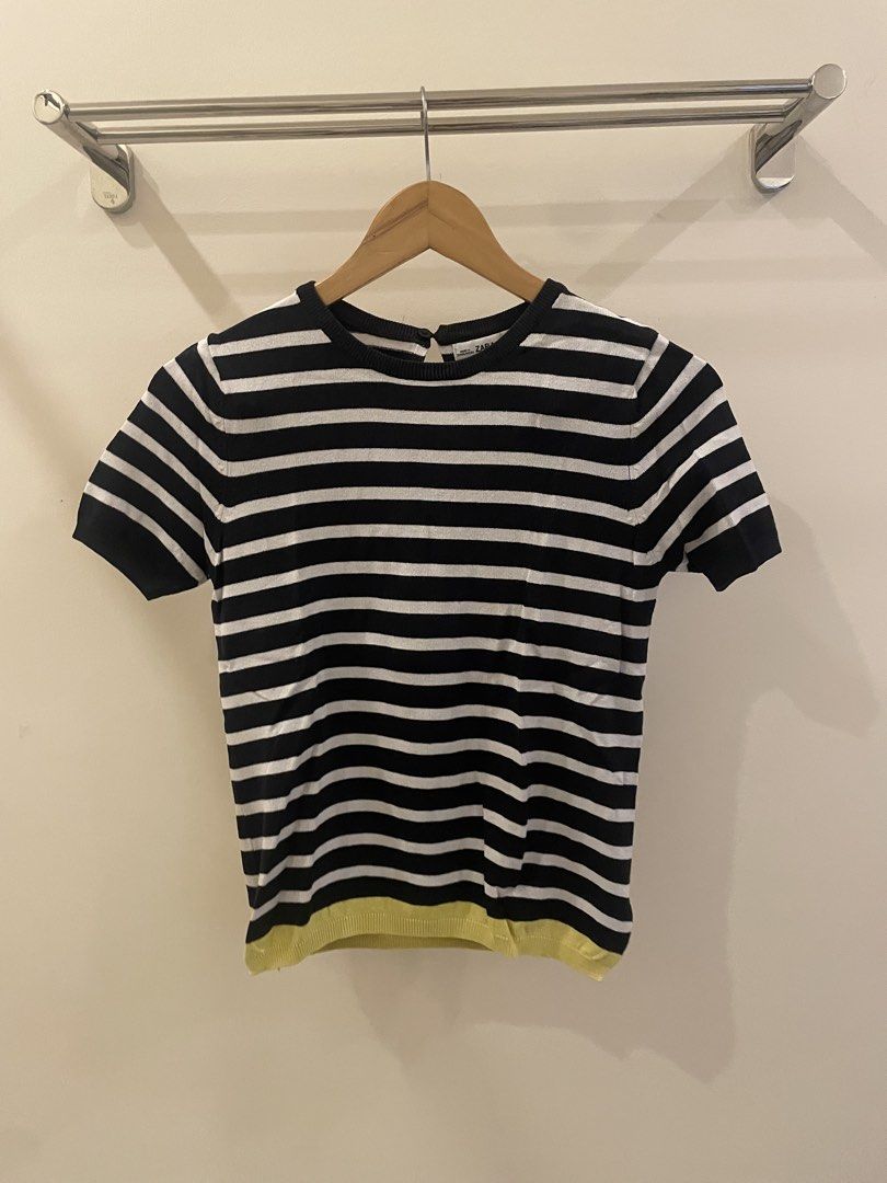 Zara Knit Striped Short Sleeve Top (Category: Blouses) located in Cordon. Submitted by secondgreatt (Listing ID 1450959522, Image 1). Description: - Zara black and white striped knit top - Features a unique yellow hem detail - Short sleeves and classic crew neck - Convenient button closure at the back of the neck - Crafted in Bangladesh.