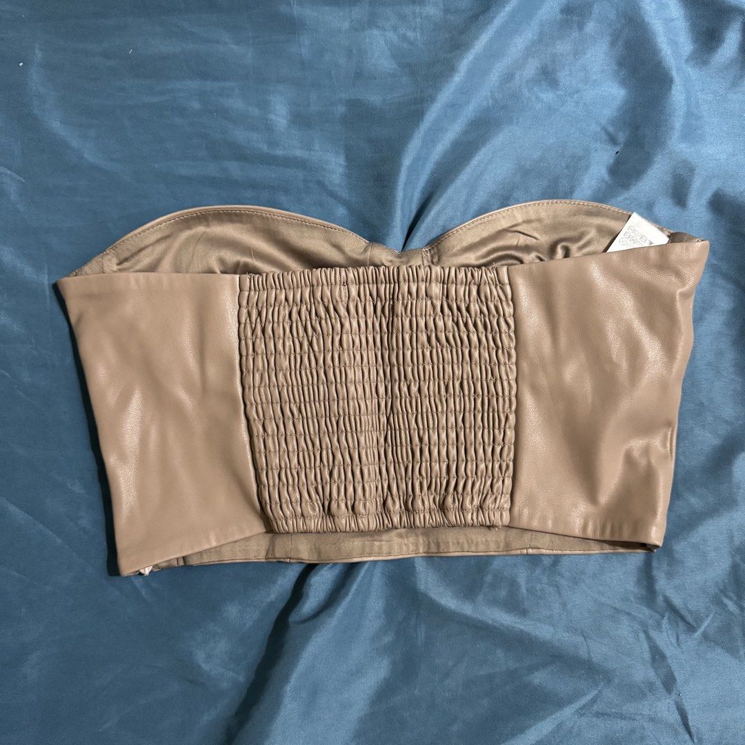 Zara Taupe Leather Corset Top (Category: Sleeveless) located in Aloran. Submitted by kheyx (Listing ID 1451075437, Image 2). Description: - Taupe faux leather corset top - Sweetheart neckline with structured cups - Smocked back for a snug fit - Side zipper closure - Versatile styling: pairs well with jeans or skirts - Super chic and trendy.