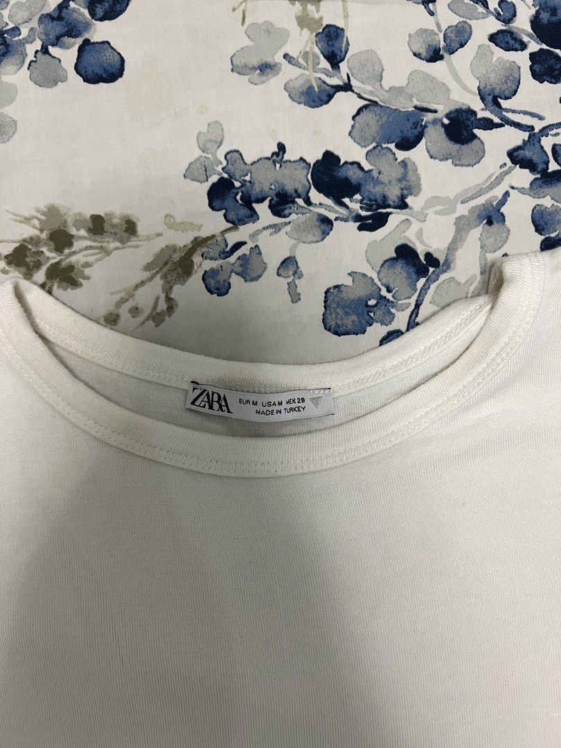 Zara White Cropped T-Shirt Size M (Category: Shirts) located in Manila. Submitted by lindseybentables (Listing ID 1451031411, Image 2). Description: - Basic white cropped t-shirt from Zara - Stretchy Fabric - Short sleeves and crew neck - Made in Turkey - Versatile for layering or wearing on its own - Easy to style with any outfit - I’m usually a size S but with broad shoulders, and this fits tight.