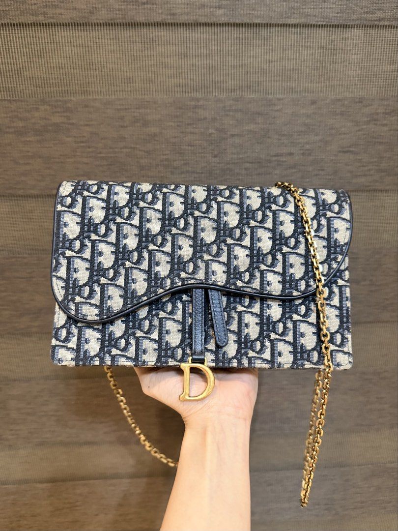 99% NEW Dior Saddle Medium Chain Pouch WOC Oblique Canvas (Category: Luxury Bags & Wallets) located in Manila. Submitted by sweetluxuryph (Listing ID 1451322178, Image 1). Description: - Authentic Dior Saddle Wallet on Chain - Iconic Dior Oblique canvas - Gold-tone hardware - Signature 'D' stirrup detail - Detachable chain strap - Ideal for essentials and evening use -Complete Set.