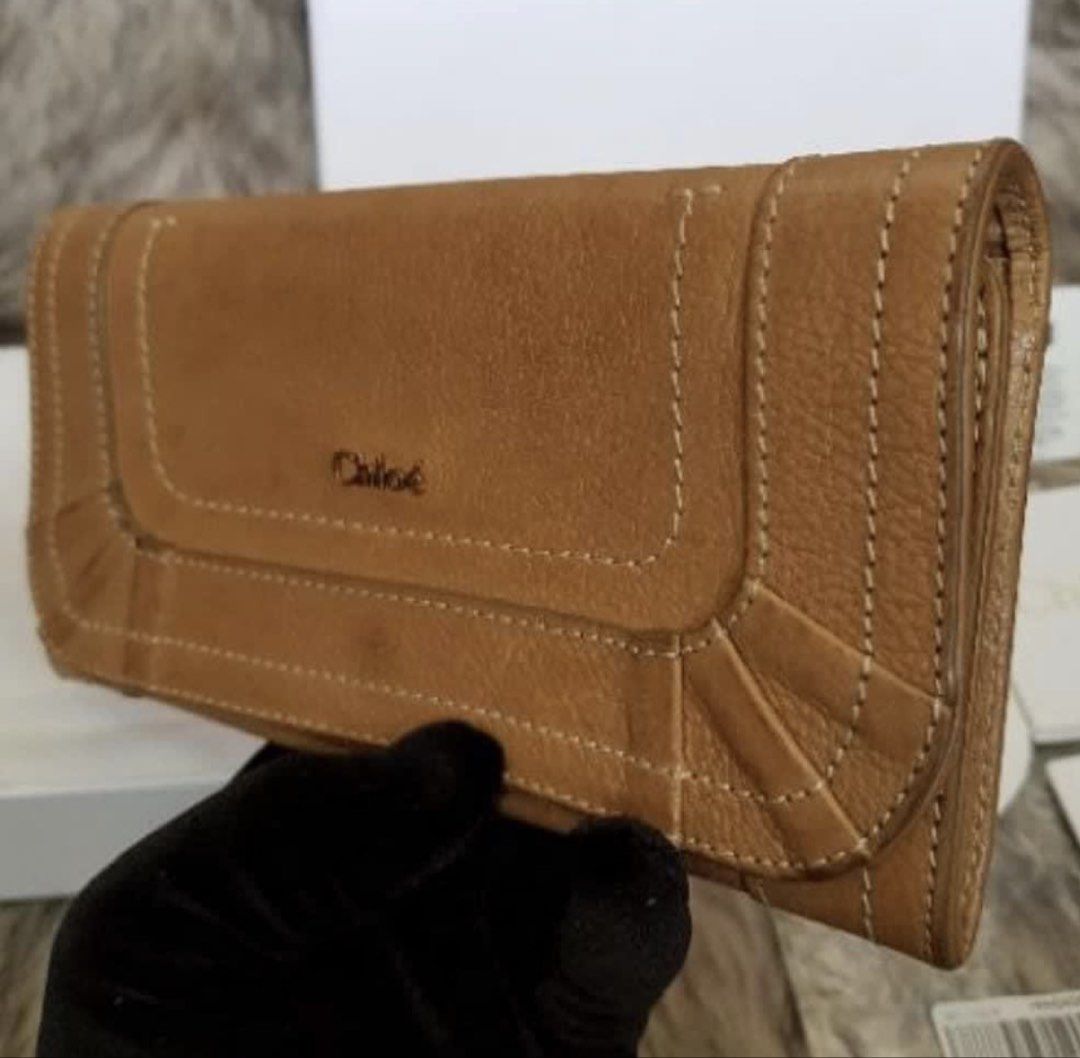 RUSH! Authentic Preloved Chloe Calfskin Long Wallet (Category: Luxury Bags & Wallets) located in Baguio. Submitted by designerbin.ph (Listing ID 1451236192, Image 2). Description: Authentic Preloved Chloe Calfskin Long Wallet Made in Spain Condition: Signs of normal use with watermarks. No major flaws. Measurement: Credit Card Slots - 10 Bill Compartment - 2 Zippered Pocket - 1 Slip Pocket - 2 ID Window - None H - 9 cm W - 18.5 cm D - 1.5 cm Incl