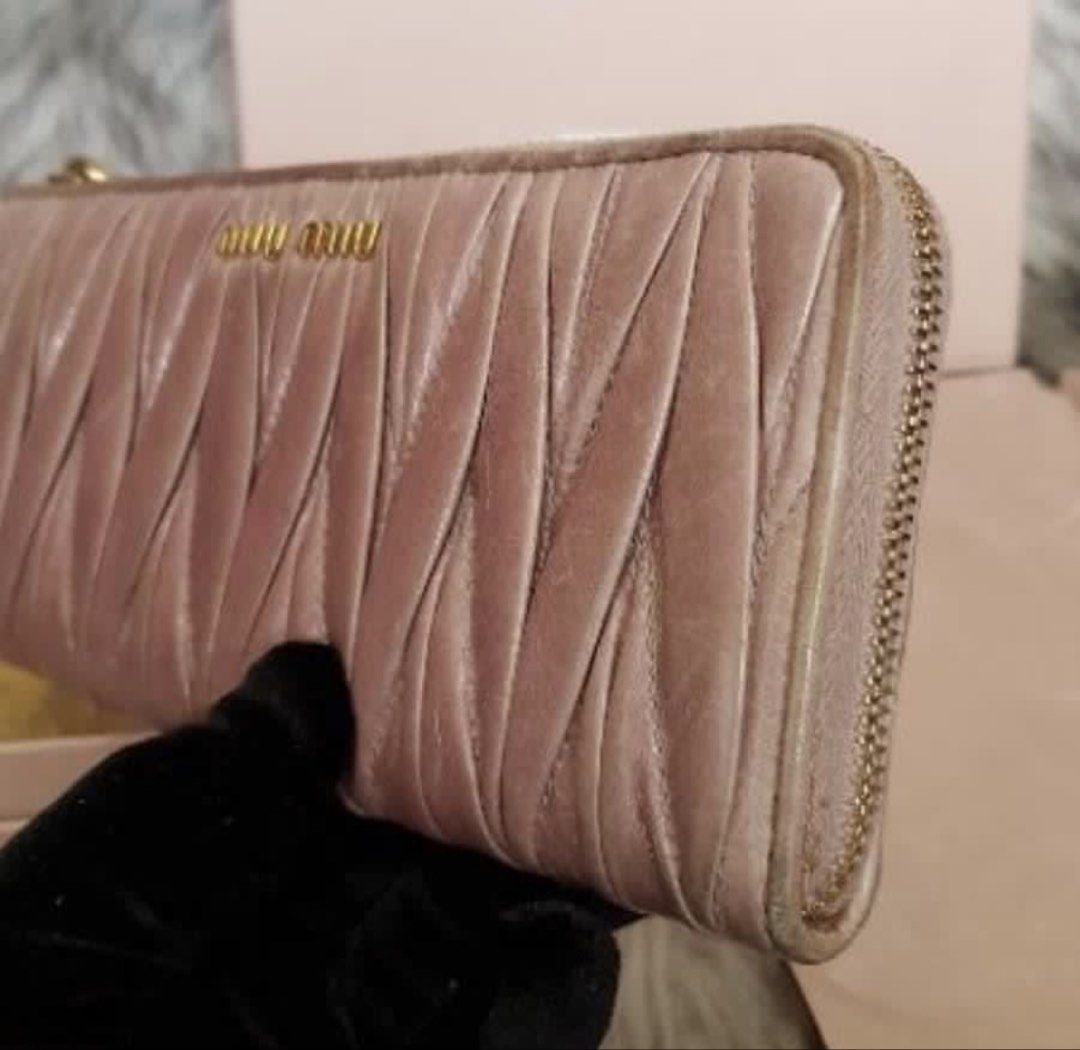 RUSH! Authentic Preloved Miu Miu Long Wallet (Category: Luxury Bags & Wallets) located in Baguio. Submitted by designerbin.ph (Listing ID 1451265138, Image 3). Description: Authentic Preloved Miu Miu Long Wallet Condition: Signs of normal use. Dirt on leather. Wear on edges. No major flaw. Measurement: Credit Card Slots - 8 Bill Compartment - 2 Zippered Pocket - 1 Slip Pocket - 2 ID Window - None H - 8.5 cm W -19 cm D - 2 cm Inclusion/s: Box Auth