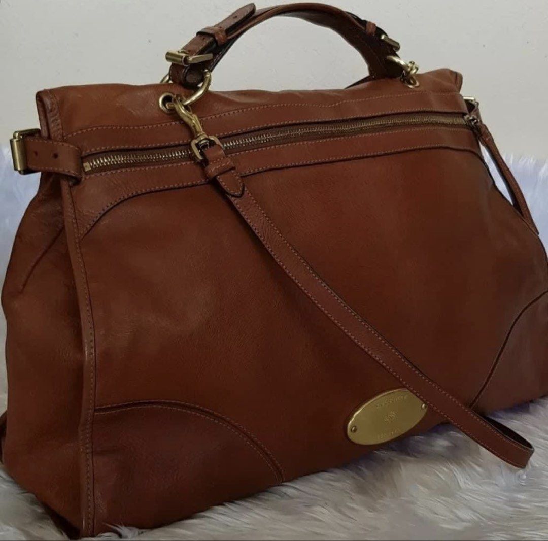 RUSH! Authentic Preloved Mulberry Satchel Bag (Category: Luxury Bags & Wallets) located in Baguio. Submitted by designerbin.ph (Listing ID 1451144705, Image 2). Description: Authentic Preloved Mulberry Satchel Bag Made in England Condition: Brown. Leather. Exterior back slip pocket with magnetic closure. Front Double zipper closure. Interior zipper pocket. Gold tone hardware. Removable strap. Gently used condition. Rank: 8/10. Some signs of norma