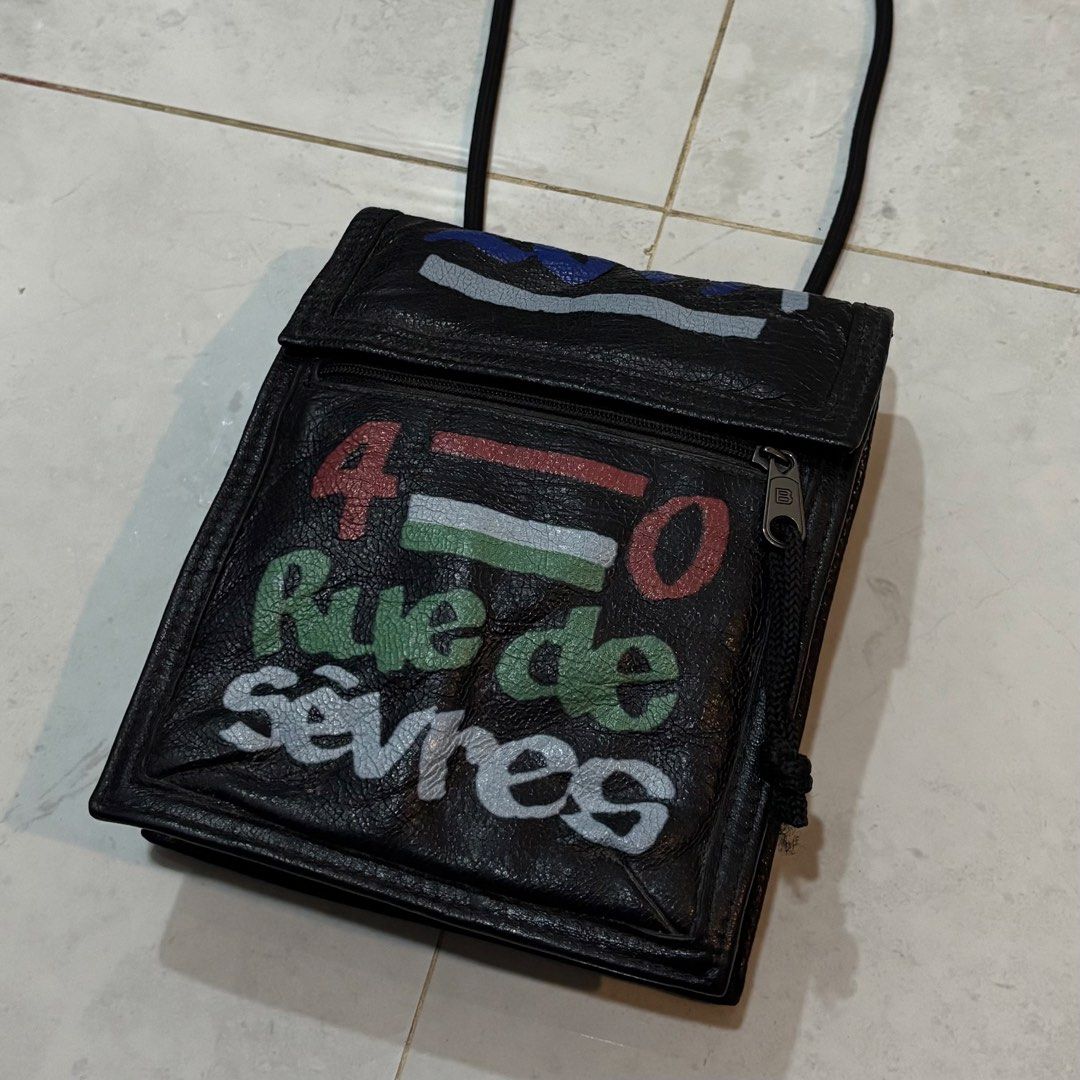 Balenciaga black leather graffiti explorer pouch (Category: Luxury Bags & Wallets) located in Cebu City. Submitted by florianmiral (Listing ID 1451263714, Image 2). Description: Balenciaga black leather graffiti explorer pouch Excellent condition .