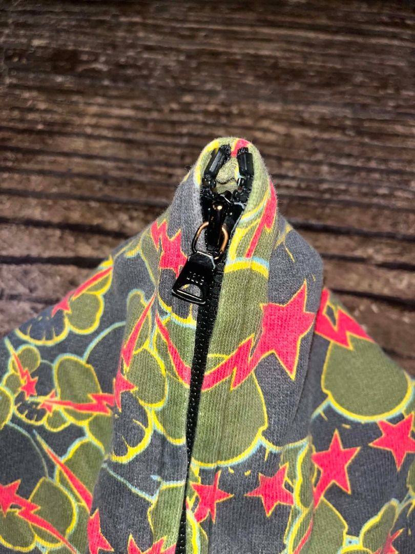 BAPE x KAWS (20005) Full Zip Hoodie Camo Skull Star Pattern AUTHENTIC (Category: Coats, Jackets and Outerwear) located in Caloocan City. Submitted by zencrystal.aca8c6 (Listing ID 1451173195, Image 3). Description: - Authentic BAPE x KAWS full zip hoodie - Features iconic camo skull and star pattern all over - Black ribbed cuffs and hem for a clean look - Ideal for everyday casual wear - A unique statement piece for your wardrobe.