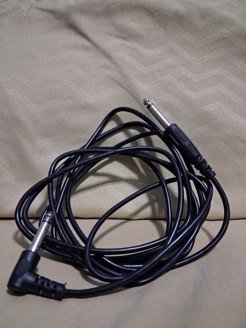 Black Audio Cable with 1/4 inch Jack Connectors (Category: Other Audio Equipment) located in Manila. Submitted by warmtree_6c8201 (Listing ID 1451276378, Image 1). Description: - Black audio cable - Features one straight 1/4 inch jack connector - Features one angled 1/4 inch jack connector - Ideal for connecting musical instruments or audio equipment - Cable is neatly coiled - Ready for a new owner.