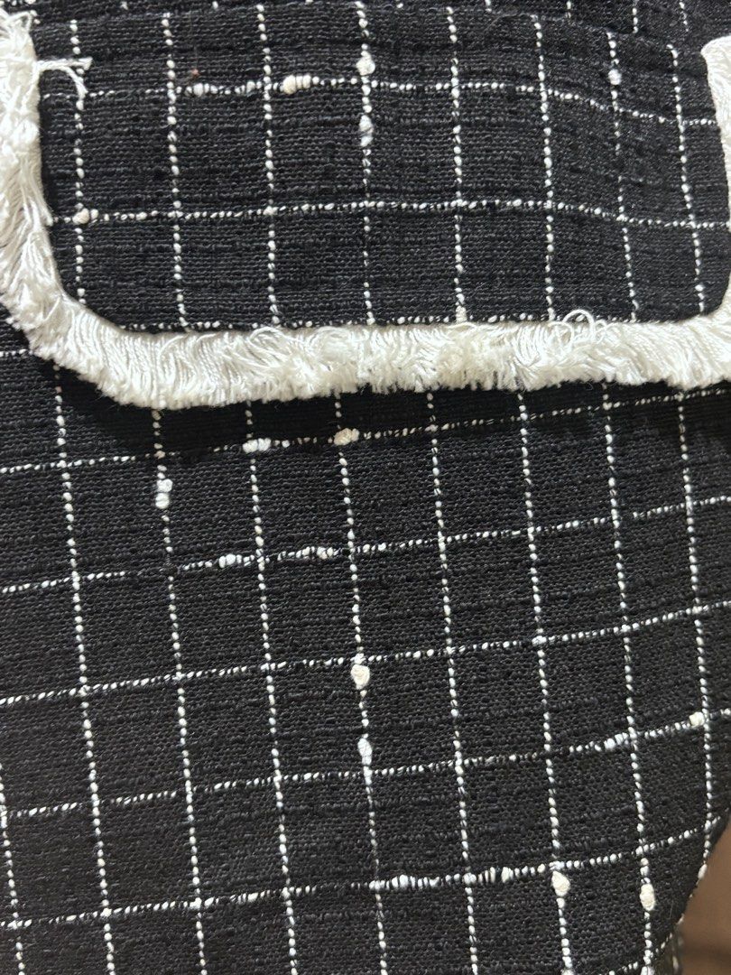 Black Grid Tweed Dress with Chain Straps (Category: Dresses) located in Manila. Submitted by laijane (Listing ID 1451157547, Image 3). Description: - Black tweed dress with a classic grid pattern. - Elegant white frayed trim on neckline and pockets. - Stylish silver chain straps. - Decorative button details on the shoulders. - Two functional front pockets. - Estimated size: Small to Medium. - Versatile for both casual outings and evening events..