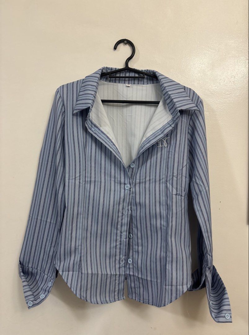 Blue Striped Fitted Button-Down Polo (Category: Longsleeves) located in Virac. Submitted by zee.mln (Listing ID 1451282350, Image 2). Description: 📌 Brand new 📌 Clean and well-kept 📌 Ready to wear Size Guide (inches) Bust: 36–38 Length: Approx. 24 Style: Office Chic | Smart Casual | Korean Fashion | Minimalist | Preppy Fitted polo, striped button-down, long sleeve blouse, blue striped shirt, collared top, fitted blouse, office wear, smart casu