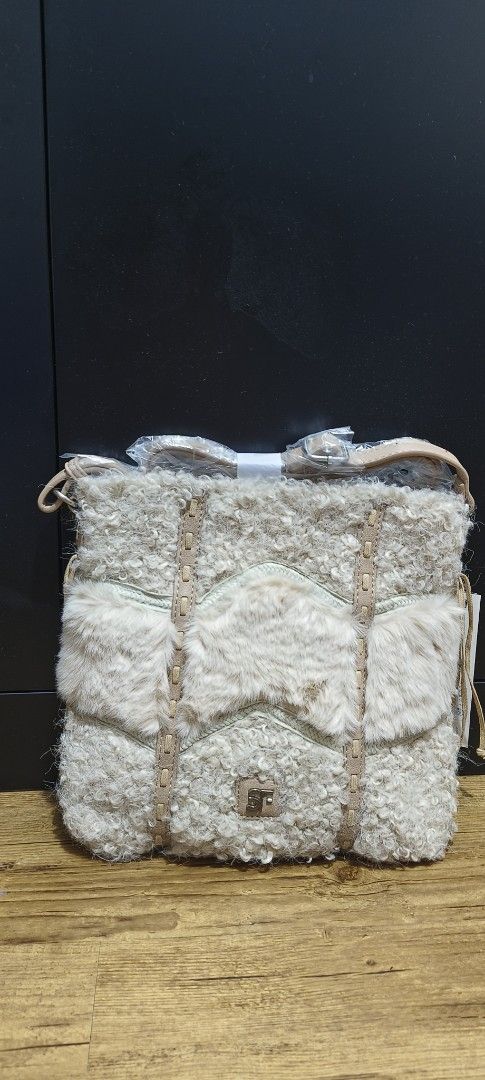 Brand new Fur Bag Cream (Category: Cross-body Bags) located in Cavite. Submitted by house_of_tabitha (Listing ID 1451155858, Image 3). Description: - Brand new cream shearling bag - Fluffy texture - Detachable strap included - Light tan leather accents - Features the SF logo in the center - Tags are still attached - super nice in actual.