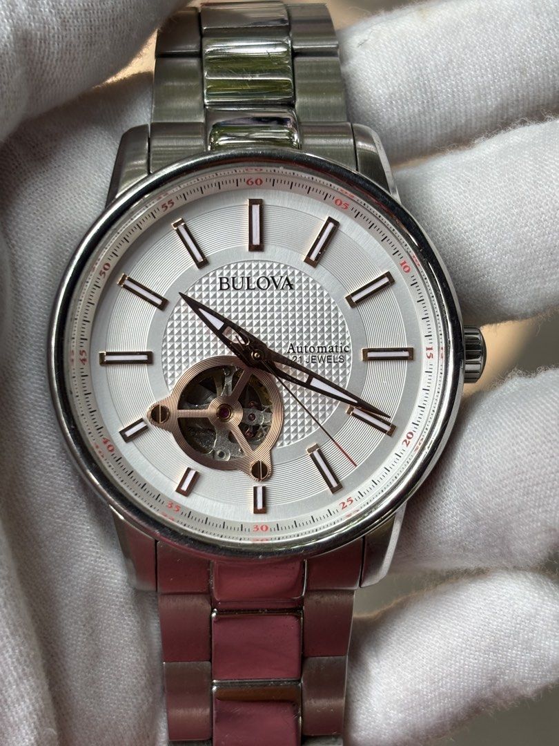 Bulova Automatic Stainless Steel Men's Watch (Category: Men's Watches) located in Bacoor. Submitted by cryptl (Listing ID 1451136446, Image 1). Description: - Bulova Automatic Watch - Silver Dial with Open Heart Design (shows movement) - Stainless Steel Band and Case - Water Resistant - 21 Jewels - Japan Movement - Clasp Closure - Ideal for everyday wear or special occasions.