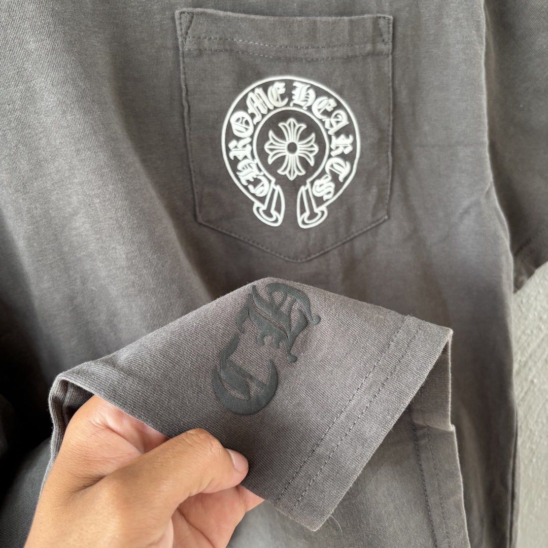 Chrome hearts tee (Category: Tshirts & Polo Shirts ) located in San Fernando. Submitted by diff.thr1ft (Listing ID 1451146574, Image 3). Description: - Brand: Chrome Hearts Tee - Size: L (EU 52 / UK 42 / US 42) - Color: Gray - Condition: Layered Condition 4/5 (Good) - Features: Front pocket logo, large back logo, sleeve detail, neck print - Style: Casual, streetwear - Meetup Location: San Fernando Elementary School, Pampanga.