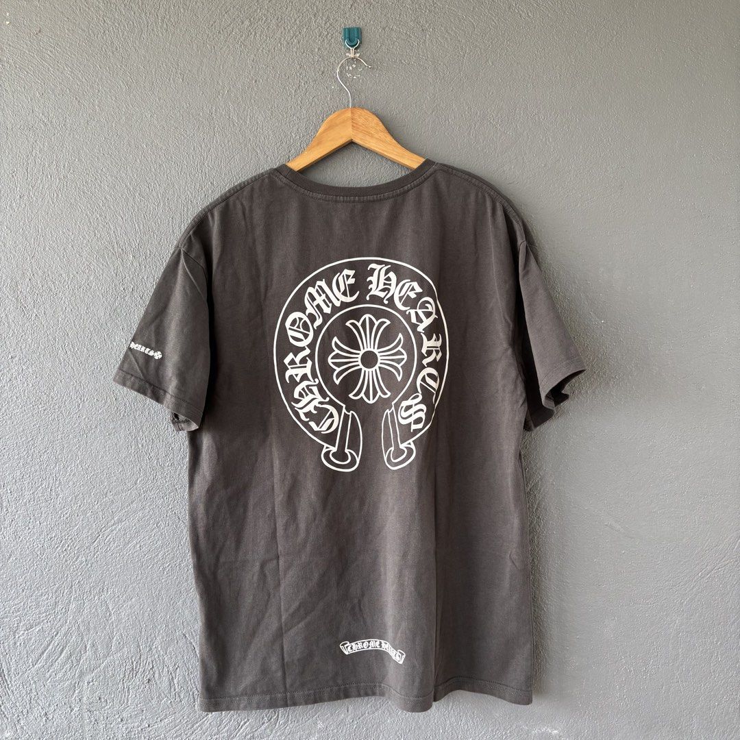 Chrome hearts tee (Category: Tshirts & Polo Shirts ) located in San Fernando. Submitted by diff.thr1ft (Listing ID 1451146574, Image 2). Description: - Brand: Chrome Hearts Tee - Size: L (EU 52 / UK 42 / US 42) - Color: Gray - Condition: Layered Condition 4/5 (Good) - Features: Front pocket logo, large back logo, sleeve detail, neck print - Style: Casual, streetwear - Meetup Location: San Fernando Elementary School, Pampanga.