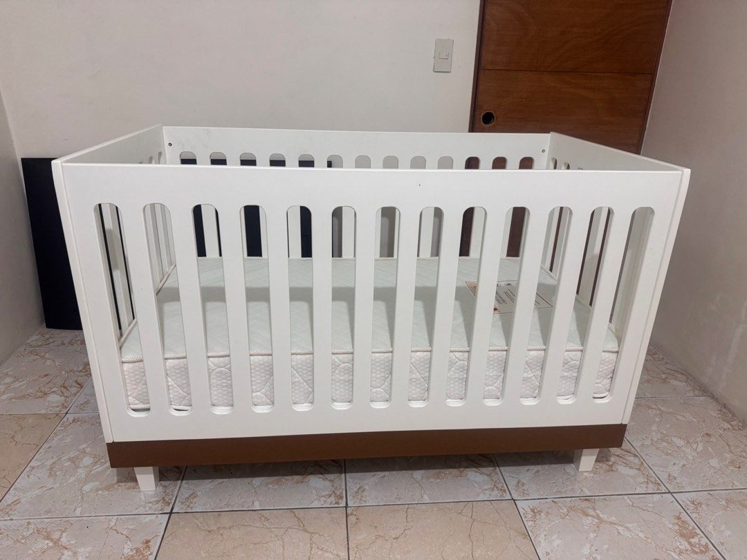 Cuddlebug Madison 3in1 Crib - Coffee (Category: Cots & Cribs) located in Bulacan. Submitted by _thriftlane (Listing ID 1451272755, Image 1). Description: - White crib with a sturdy brown base - Includes Cuddlebug Cool Comfort crib mattress - Mattress is clean and comes with a protective cover - Ready for its next loving home.