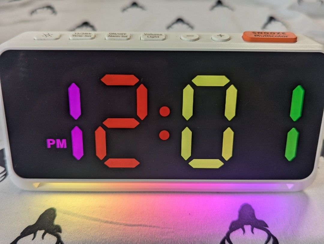 Digital Alarm Clock with RGB Lighting (Category: Clocks) located in Mandaluyong City. Submitted by sevenoctobers (Listing ID 1451155090, Image 1). Description: Digital alarm clock with vibrant RGB display and night light. Used but in good condition. Large, easy-to-read colorful time display. Adjustable snooze time (5-15 minutes). Adjustable volume and light dimmer. Seven lighting color preferences and multicolor display choices. Comes with origin