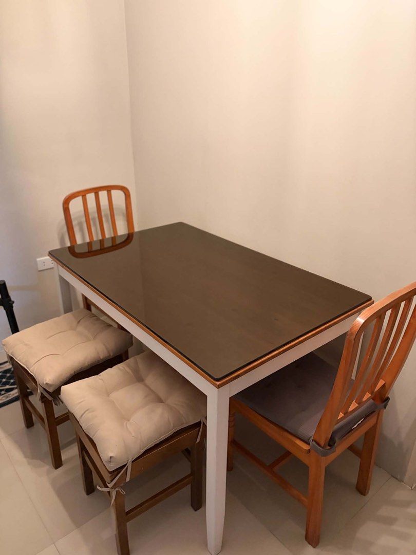 Dining Table with 4 Chairs and Cushions (Category: Tables & Sets) located in Lipa City. Submitted by eve_decluttz (Listing ID 1451287588, Image 2). Description: - Perfect for small spaces: Compact dining set. - Includes: 1 rectangular dining table (dark tabletop, white frame), 2 wooden chairs (grey cushions), 2 wooden stools (beige cushions). - .