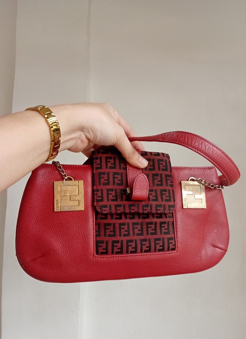 Fendi Red baguette (Category: Luxury Bags & Wallets) located in Navotas City. Submitted by ms.soulana (Listing ID 1451261416, Image 1). Description: PreOwned WellUsed Fendi Red baguette shoulder bag - Color: Red - Material: Pebbled leather and iconic Zucca monogram canvas - Hardware: Gold-tone with Fendi logo charms - Strap: Leather with chain detail - Closure: Magnetic snap Off /Legit NGA Sign of Used Flaws : Min Rubs ,faded goldtone hardware , 