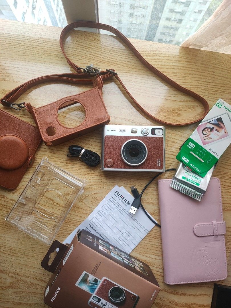 Fujifilm Instax Mini Evo (Category: Cameras) located in Manila. Submitted by heyitssef (Listing ID 1451209221, Image 2). Description: Almost new. 3x lang nagamit. Fixed price dahil sa inclusions. MUST TAKE ALL. Inclusions: 1 Clear Case 1 Leather Case Photo album 10pcs instax film Box Charging Cord 16GB SD card Lightning usb (file transfer).