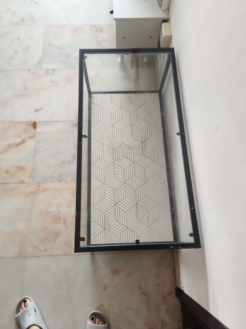 Geometric Pattern Coffee Table (Category: Tables & Sets) located in Singapore. Submitted by yapbibi8351536 (Listing ID 1447831682, Image 2). Description: - Two-tier coffee table - Black metal frame - White mesh top shelf - Geometric patterned bottom shelf (white & gold) - Ideal for living room or study - Easy to assemble.