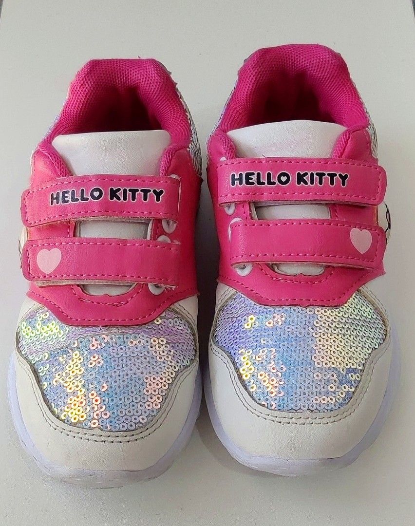 Hello Kitty Pink/White Sequined Velcro Sneakers (Category: Babies & Kids Fashion) located in Las Pinas. Submitted by thechaptermarketph (Listing ID 1451177742, Image 1). Description: - Adorable bright pink/white Hello Kitty sneakers for kids. - Pre-loved but in excellent condition - Features eye-catching sparkly sequin details on the front. - Convenient velcro straps for easy on and off. - Ideal for everyday wear, school, or casual occasions. RFS