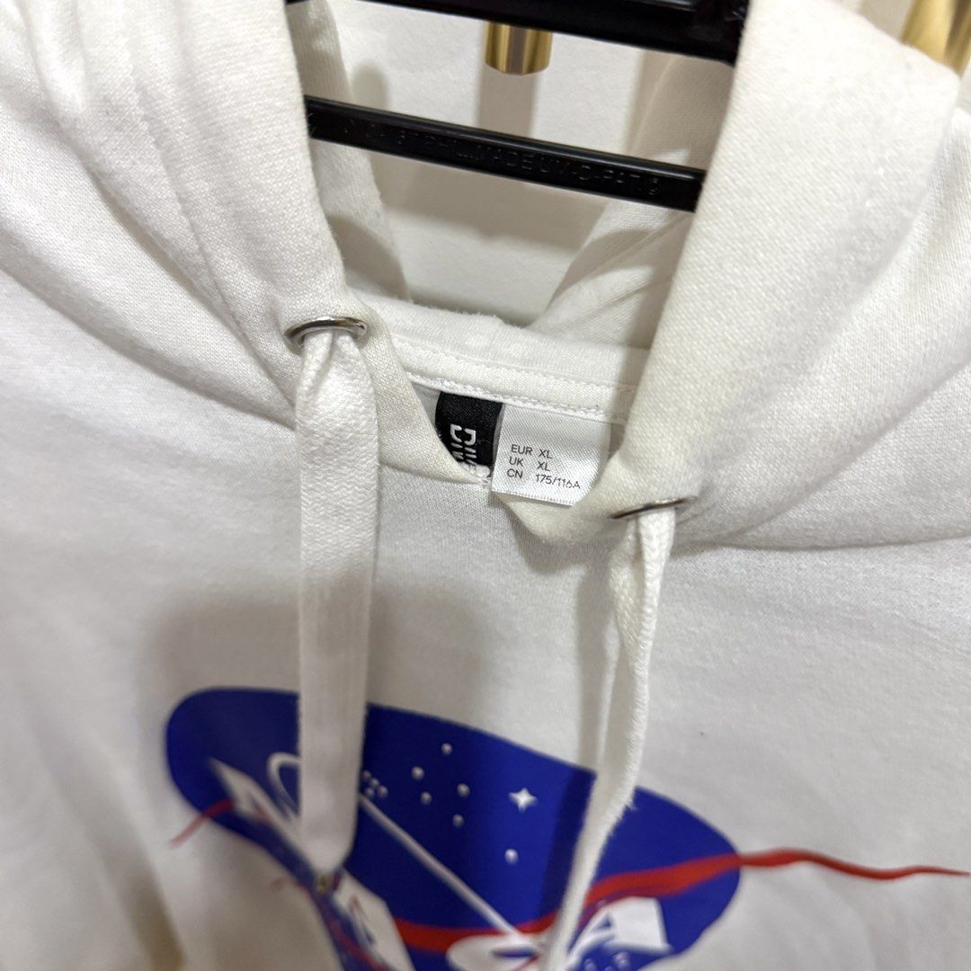 H&M White NASA Hoodie (Category: Coats, Jackets and Outerwear) located in Cainta. Submitted by ac.decluttering (Listing ID 1451319361, Image 3). Description: H&M White NASA Hoodie Size: XL Rarely used Has a minor flaw (please see photos) .