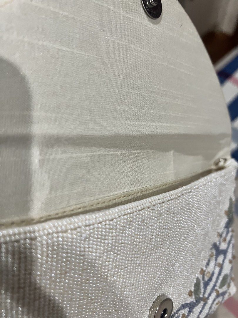 Ivory Beaded Clutch Bag with Top Handle (Category: Clutches) located in Manila. Submitted by limonee (Listing ID 1451264915, Image 2). Description: Bought from @alexrosecairo on IG on Feb 2026 Used 2x only. Exterior beadwork is intact with no flaws. Interior is clean but the inner lining has visible crease lines (see photos), this does not affect the bag’s use naman.