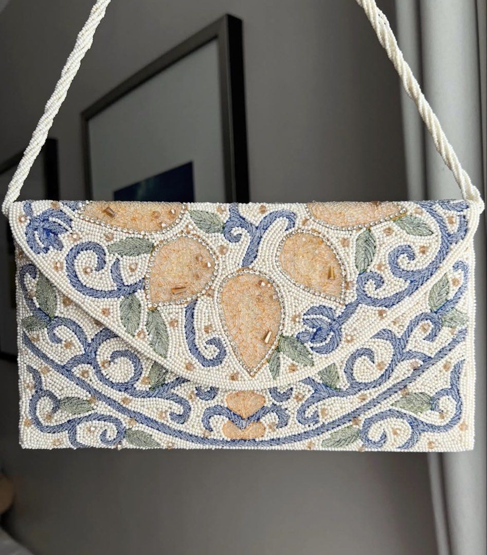 Ivory Beaded Clutch Bag with Top Handle (Category: Clutches) located in Manila. Submitted by limonee (Listing ID 1451264915, Image 1). Description: Bought from @alexrosecairo on IG on Feb 2026 Used 2x only. Exterior beadwork is intact with no flaws. Interior is clean but the inner lining has visible crease lines (see photos), this does not affect the bag’s use naman.