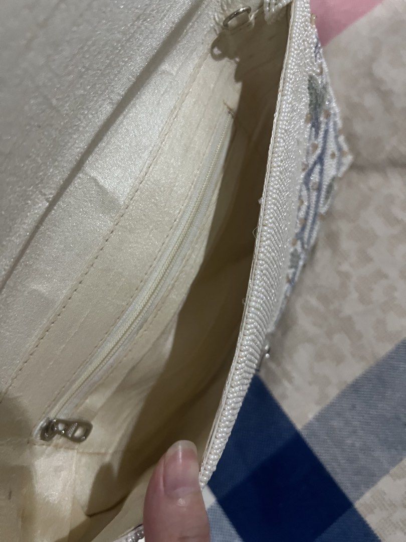 Ivory Beaded Clutch Bag with Top Handle (Category: Clutches) located in Manila. Submitted by limonee (Listing ID 1451264915, Image 3). Description: Bought from @alexrosecairo on IG on Feb 2026 Used 2x only. Exterior beadwork is intact with no flaws. Interior is clean but the inner lining has visible crease lines (see photos), this does not affect the bag’s use naman.