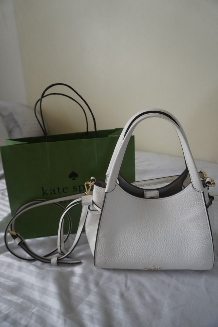 Kate Spade Stash Small Carryall Bag (Category: Luxury Bags & Wallets) located in Liloan. Submitted by nezucart (Listing ID 1445852295, Image 1). Description: Original Kate Spade Got this from my recent trip to the US RFS: I only used this for a two-week trip so it's practically new, and I bought another bag. - Brand: Kate Spade New York - Material: White pebbled leather - Style: Bucket bag/Cross-body - Features: Top handles, detachable crossbody 