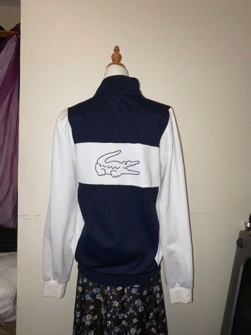 Lacoste Sport SH6937 Jacket (Category: Coats, Jackets and Outerwear) located in Quezon City. Submitted by thriftjunks (Listing ID 1451160428, Image 2). Description: - Brand: Lacoste Sport - Model: SH6937 Jacket - Color: Navy and White - Size: US S - Features: Full zip front, iconic Lacoste crocodile logo on chest and back, side pockets - Condition: Great - Style: Sporty, casual.