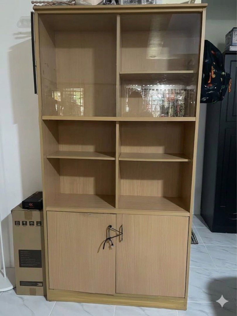 Light Oak Multi-Tier Cabinet (Category: Shelves, Cabinets & Racks) located in Quezon City. Submitted by corem (Listing ID 1451174214, Image 1). Description: Versatile, multi-functional wooden cabinet with a light oak finish. Features an upper glass-door display tier, middle open bookshelves, and a spacious bottom storage cabinet. Ideal for living rooms, offices, or bedrooms.✨ ConditionUpper & Middle Tiers: Excellent, pristine condition.Base Secti