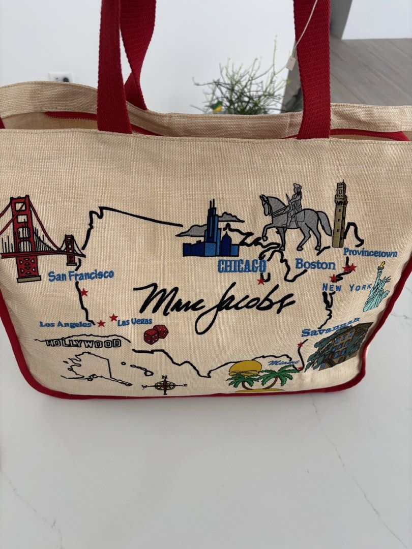 Marc Jacobs USA Map Tote Bag (Category: Luxury Bags & Wallets) located in Muntinlupa City. Submitted by nicethingsforsale1 (Listing ID 1451150399, Image 2). Description: - Authentic Marc Jacobs tote bag - Unique USA map design with embroidered landmarks (San Francisco, Chicago, New York, Miami) - Made from natural jute material - Accented with red trim and handles - Spacious and ideal for travel or everyday essentials.