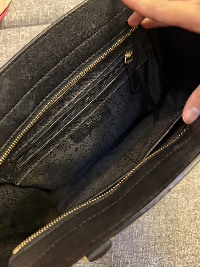 Michael Kors Black Leather Tote Bag (Category: Luxury Bags & Wallets) located in San Jose. Submitted by affordabletrendsby_cai (Listing ID 1451223270, Image 3). Description: - Classic black leather Michael Kors tote bag. - Elegant gold hardware details. - Ample interior space with a zippered pocket for organization. - Comfortable top handles for easy carrying. - Protective metal feet on the bottom to prevent wear. - An ideal, stylish bag for ever
