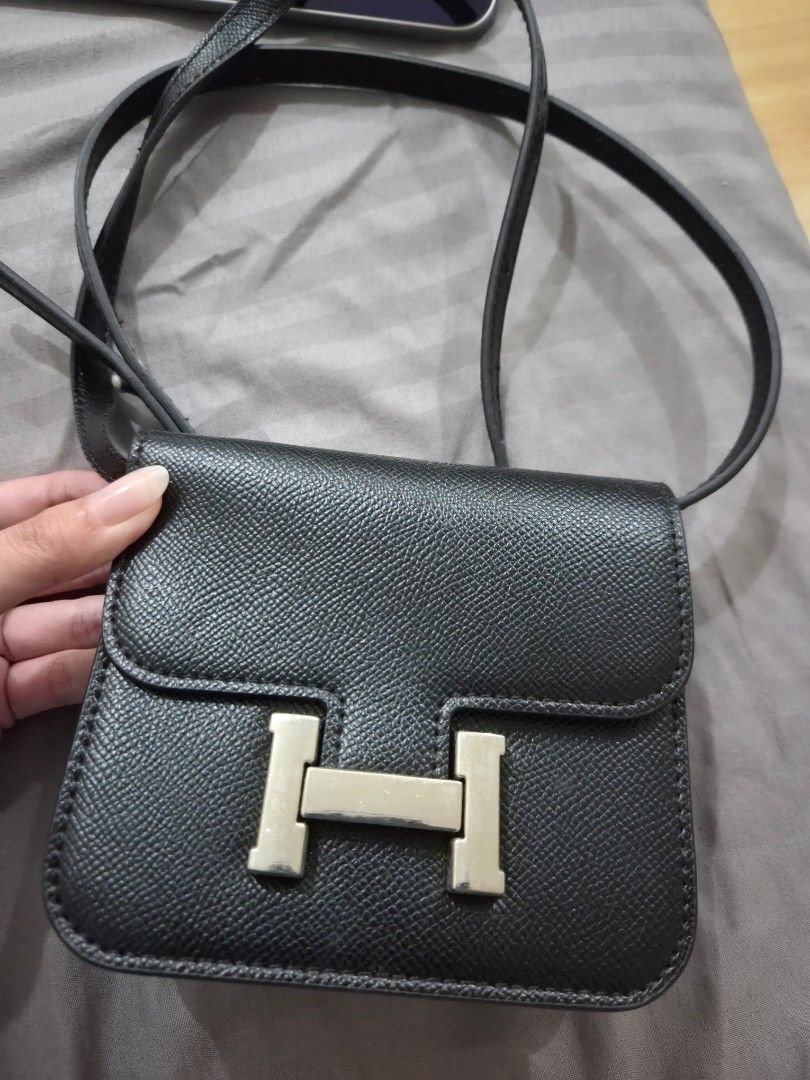 MICRO SLING Black Crossbody Bag with Silver 'H' Clasp (Category: Cross-body Bags) located in Quezon City. Submitted by loved.stuff143 (Listing ID 1451300108, Image 2). Description: - Black textured crossbody bag or belt bag - Silver-tone metal clasp resembling an 'H' - Adjustable strap for comfortable wear - Small and compact, ideal for carrying essentials - Clean interior - Minimal exterior wear - Perfect for casual outings.