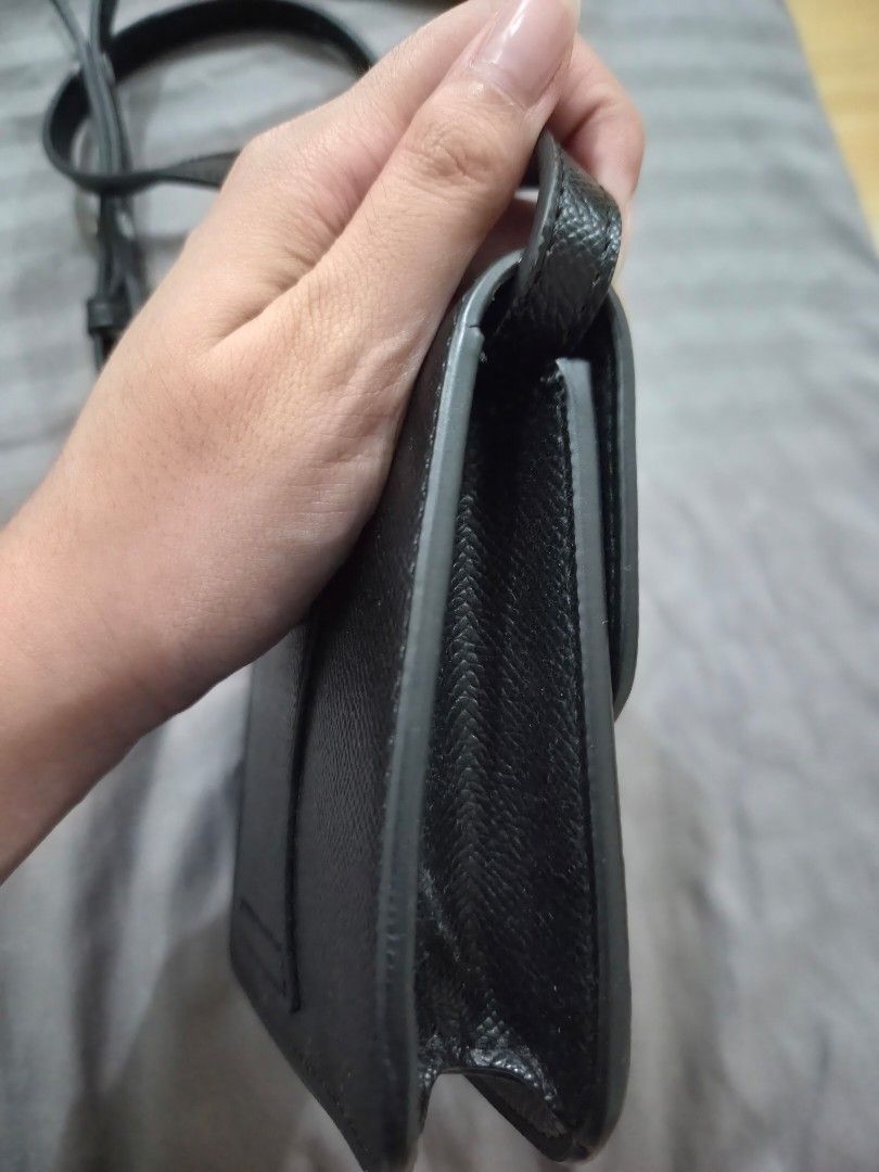 MICRO SLING Black Crossbody Bag with Silver 'H' Clasp (Category: Cross-body Bags) located in Quezon City. Submitted by loved.stuff143 (Listing ID 1451300108, Image 3). Description: - Black textured crossbody bag or belt bag - Silver-tone metal clasp resembling an 'H' - Adjustable strap for comfortable wear - Small and compact, ideal for carrying essentials - Clean interior - Minimal exterior wear - Perfect for casual outings.