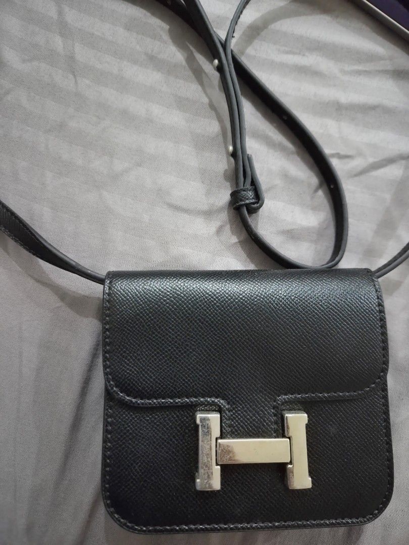 MICRO SLING Black Crossbody Bag with Silver 'H' Clasp (Category: Cross-body Bags) located in Quezon City. Submitted by loved.stuff143 (Listing ID 1451300108, Image 1). Description: - Black textured crossbody bag or belt bag - Silver-tone metal clasp resembling an 'H' - Adjustable strap for comfortable wear - Small and compact, ideal for carrying essentials - Clean interior - Minimal exterior wear - Perfect for casual outings.