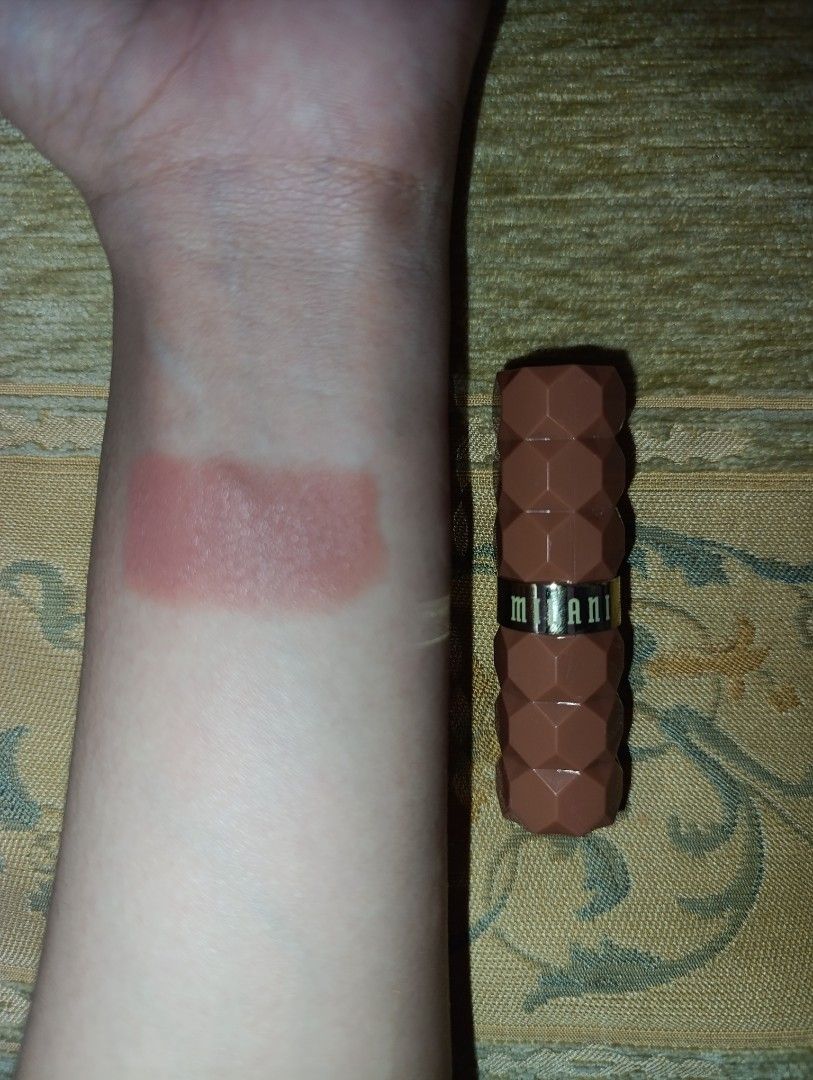 Milani Lipstick Swatched on Arm (Category: Makeup) located in Manila. Submitted by k.beauty.cloud (Listing ID 1451199673, Image 1). Description: - Milani Lipstick - Shade: Warm Nude-Pink - Condition: Swatched once on arm - Packaging: Unique textured design - Ideal for: Everyday wear.